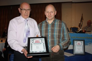 Jim Belshaw (l) collects the Merit Award at Dunsilly Hotel. 