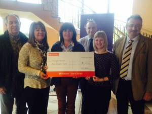 The Beattie Family present a cheque for £3,000 to the Meningitis Research Foundation. 